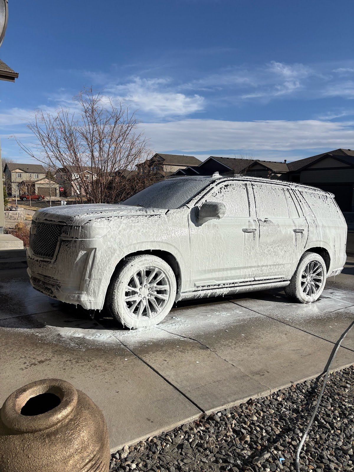 An SUV covered in wash suds mid hand-wash by RedOne Auto Mobile Detailing